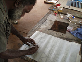 Artist Kenny Brown working on an etching plate during a printmaking workshop held at Jilamara Arts and Crafts in March 2006.