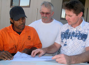Student Tyrone Lynch discussing plans with CDU lecturer Bob Benson and Peter Lynch, project manager, NT Link